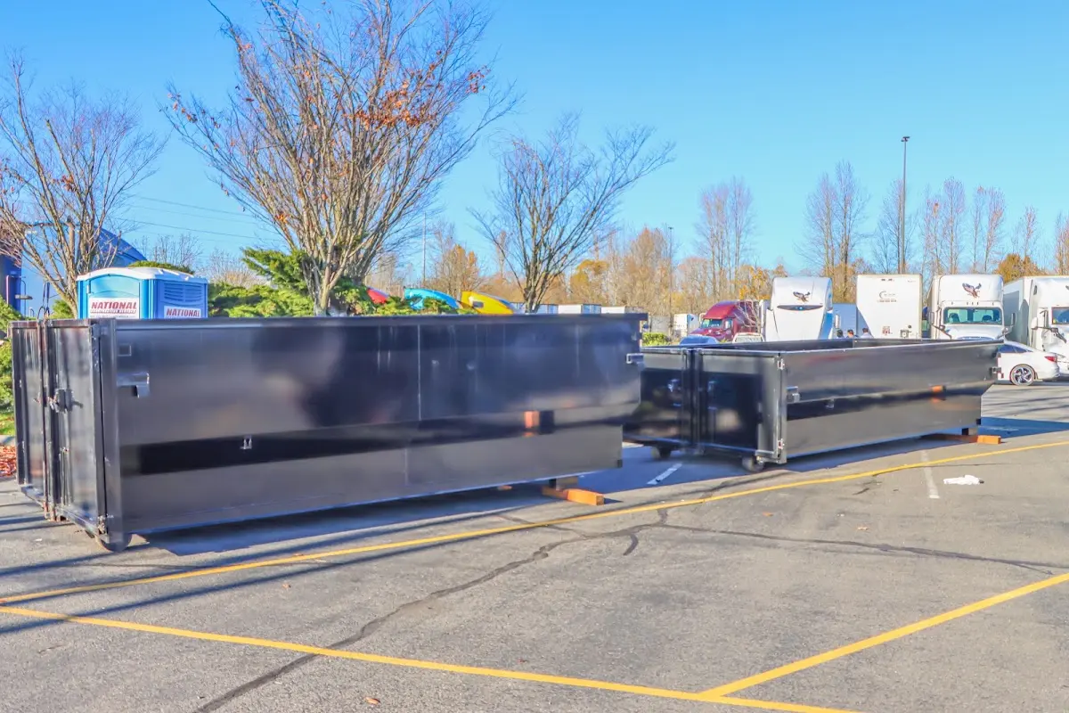 Professional dumpster rental service with roll-off container on residential driveway in Beloit